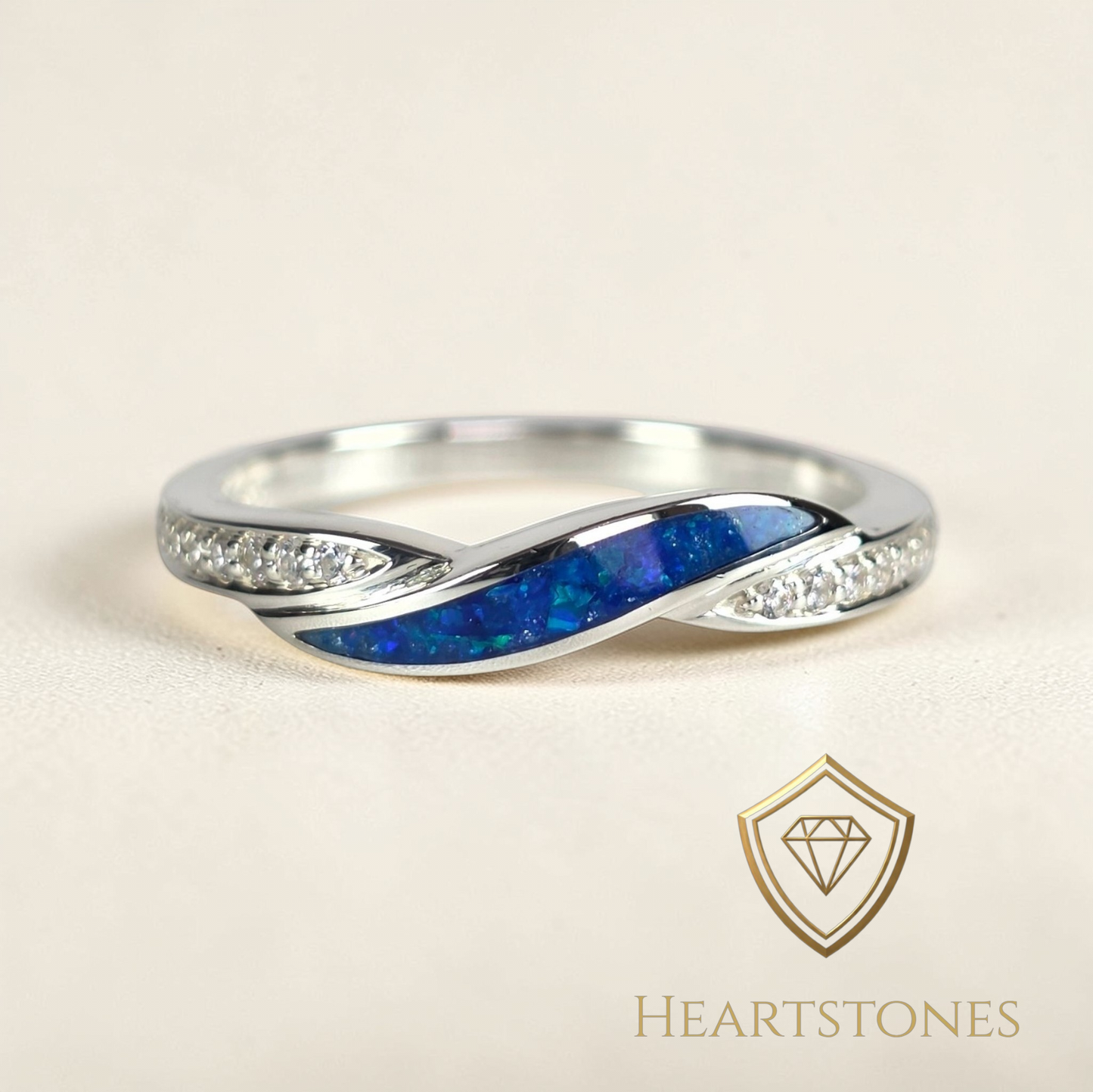 “Sterling silver twist memorial ring with blue opal and ash inlay and pavé set shoulders, meticulously finished by hand by Heartstones®”