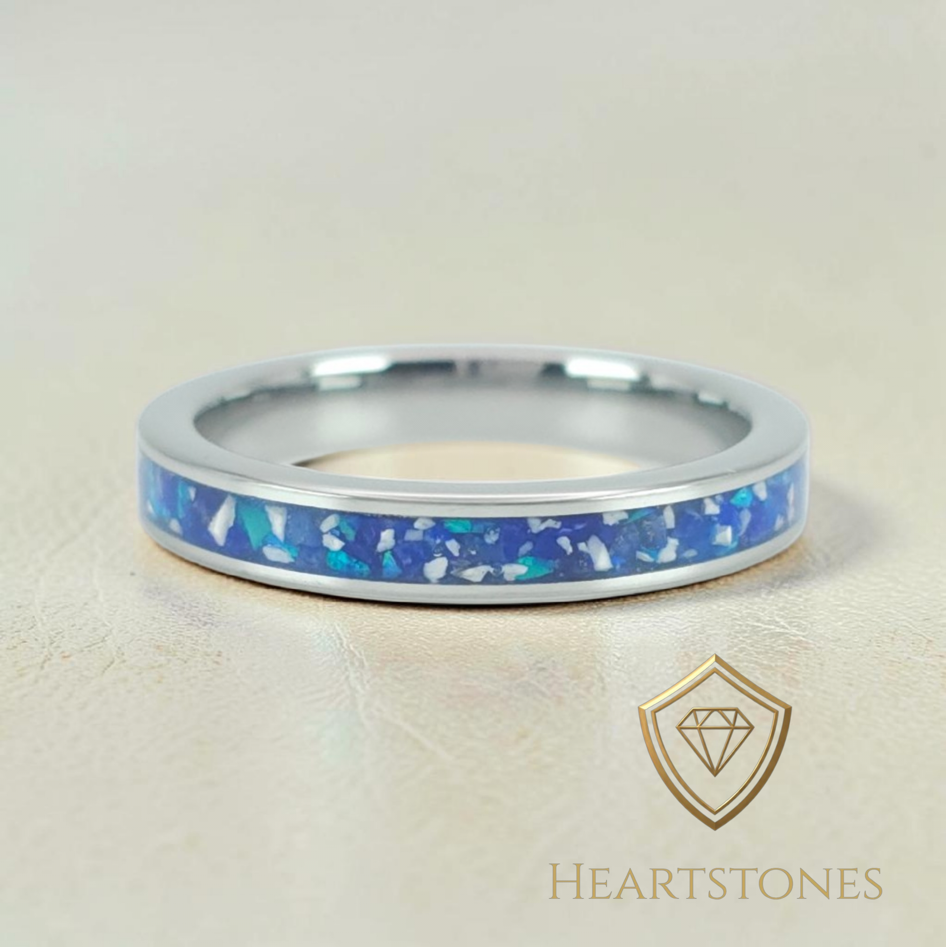 “Sterling silver memorial band ring with blue ash and opal inlay, flush set and meticulously finished by hand by Heartstones®”