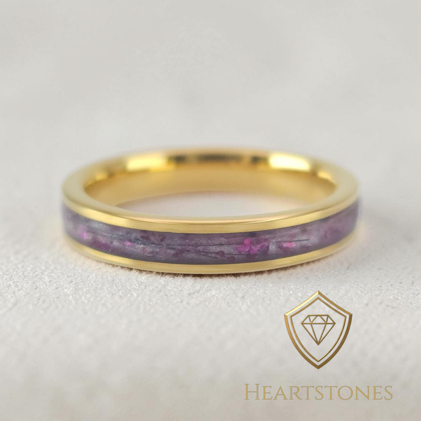 “Gold memorial band ring with preserved hair and purple inlay, flush set and meticulously finished by hand by Heartstones®”