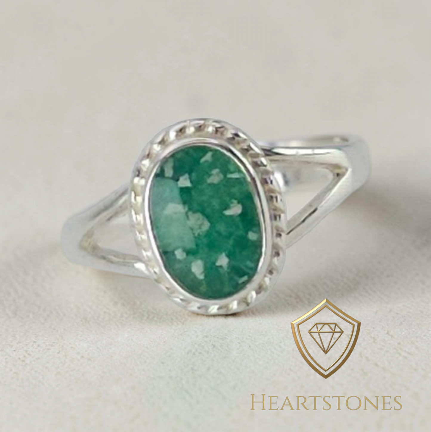 “Sterling silver memorial ring with oval emerald and ash inlay, flush set and meticulously finished by hand by Heartstones®”