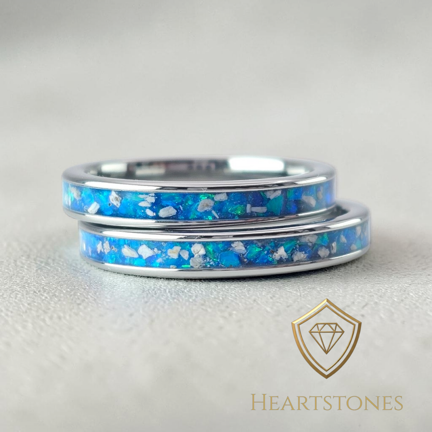 “Sterling silver memorial wedding band rings with blue ash and opal inlay, flush set and meticulously finished by hand by Heartstones®”