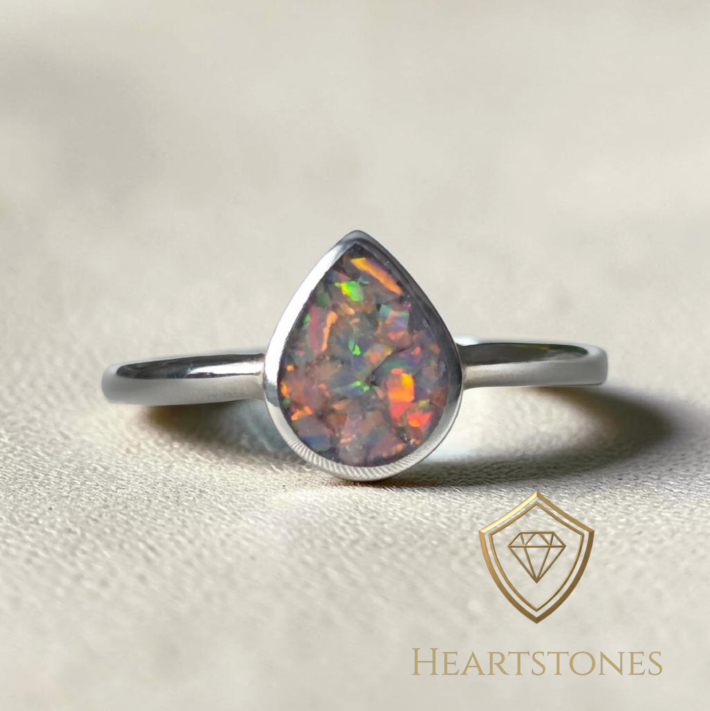 “Sterling silver teardrop memorial ring with opal inlay, flush set and meticulously finished by hand by Heartstones®”