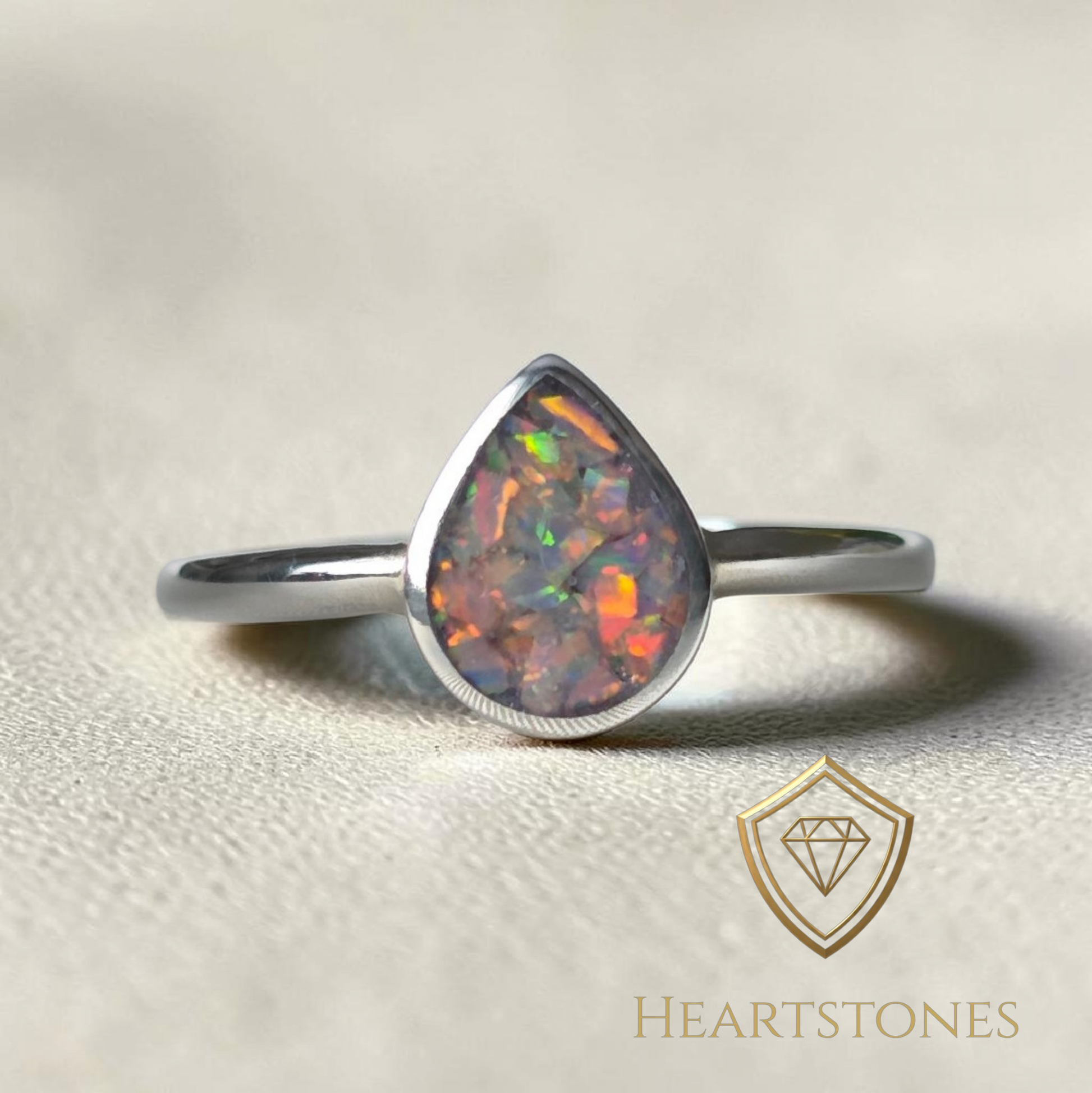 “Sterling silver teardrop memorial ring with opal inlay, flush set and meticulously finished by hand by Heartstones®”