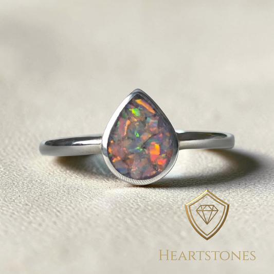 “Sterling silver teardrop memorial ring with opal inlay, flush set and meticulously finished by hand by Heartstones®”