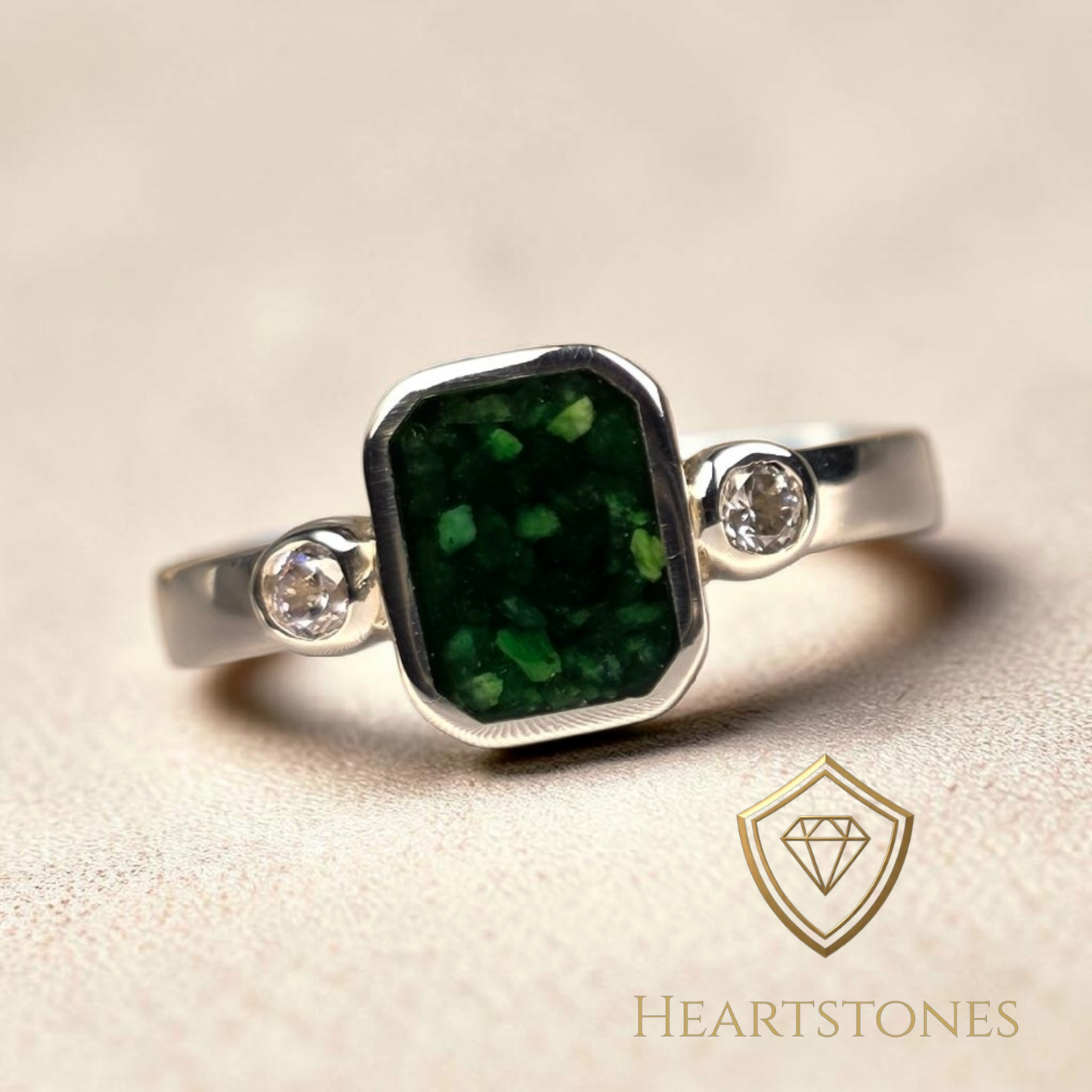 “Sterling silver memorial ring with emerald green ash inlay and side stones, flush set and meticulously finished by hand by Heartstones®”