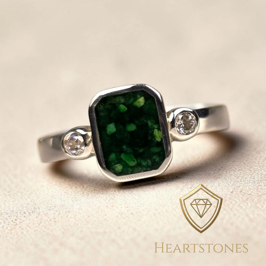 “Sterling silver memorial ring with emerald green ash inlay and side stones, flush set and meticulously finished by hand by Heartstones®”