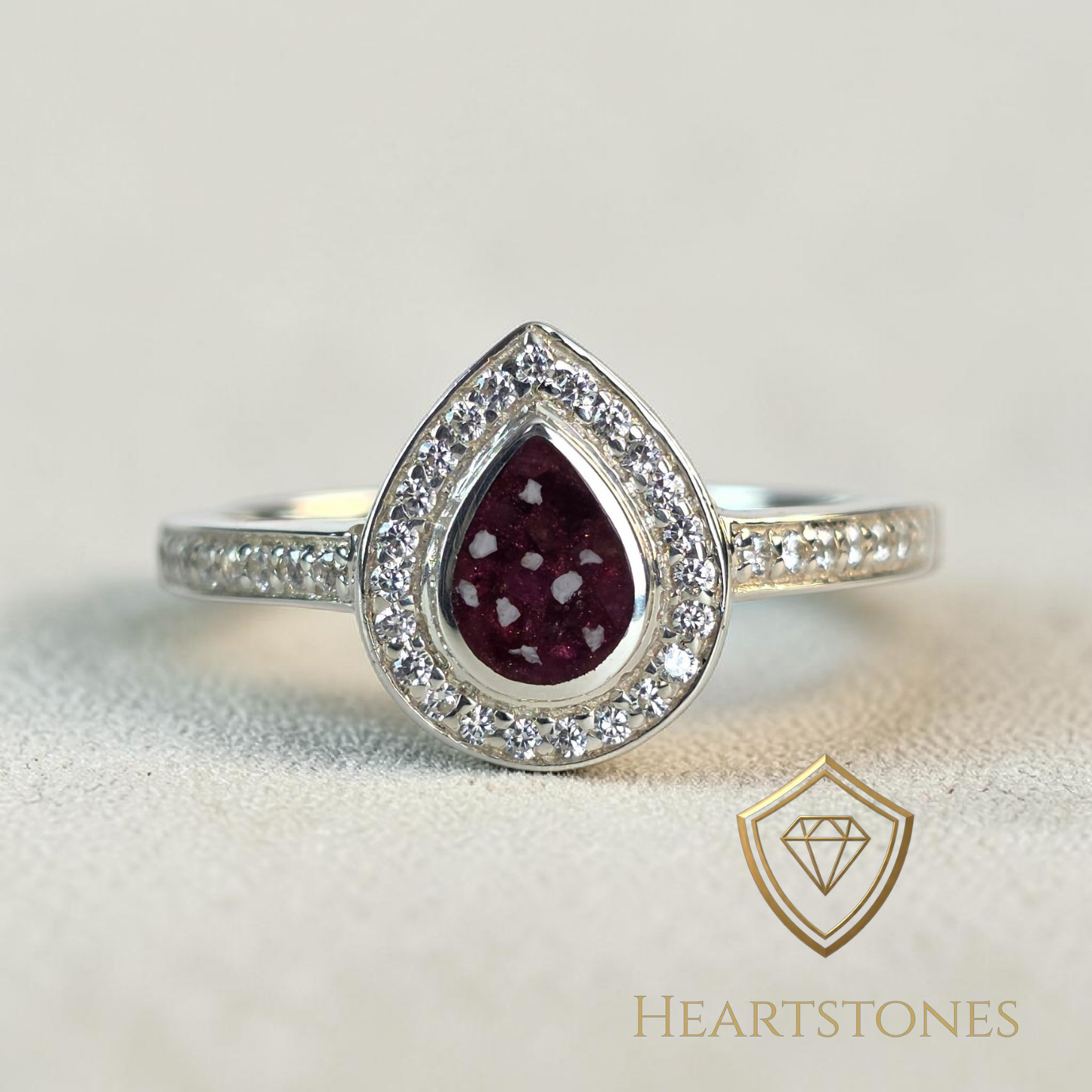 “Sterling silver teardrop memorial ring with red ash inlay and halo set stones, meticulously finished by hand by Heartstones®”