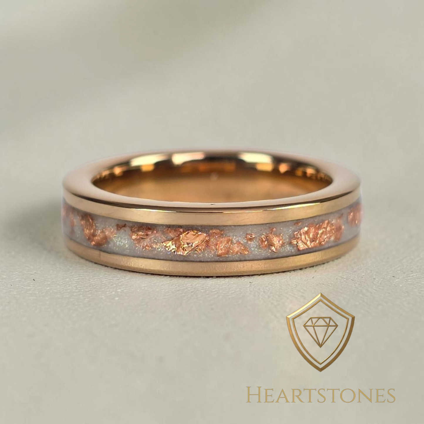“Rose gold memorial band ring with preserved breastmilk, shimmer and rose gold leaf inlay, flush set and meticulously finished by hand by Heartstones®”