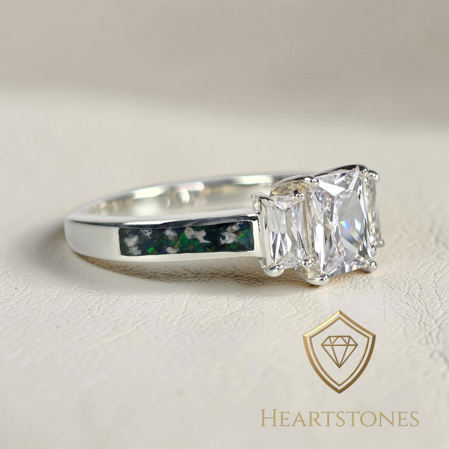 “Sterling silver memorial ring with emerald cut centre stone and green opal ash inlay band, meticulously finished by hand by Heartstones®”