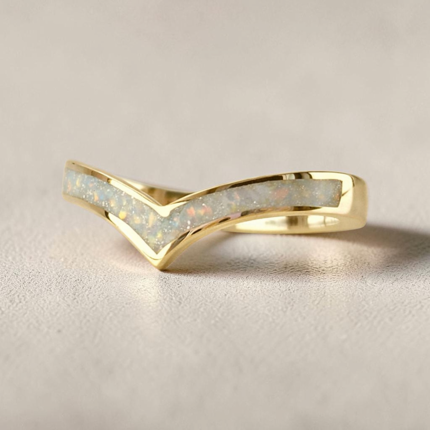 “Gold wishbone memorial ring with opal and ash inlay, flush set and meticulously finished by hand by Heartstones®”