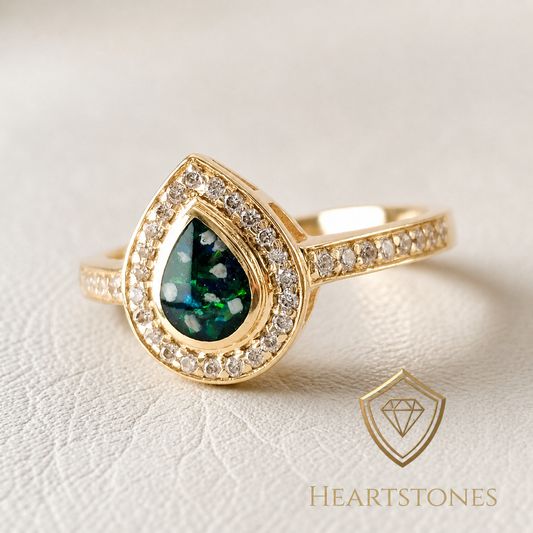 “Gold teardrop memorial ring with green ash inlay and halo set stones, meticulously finished by hand by Heartstones®”