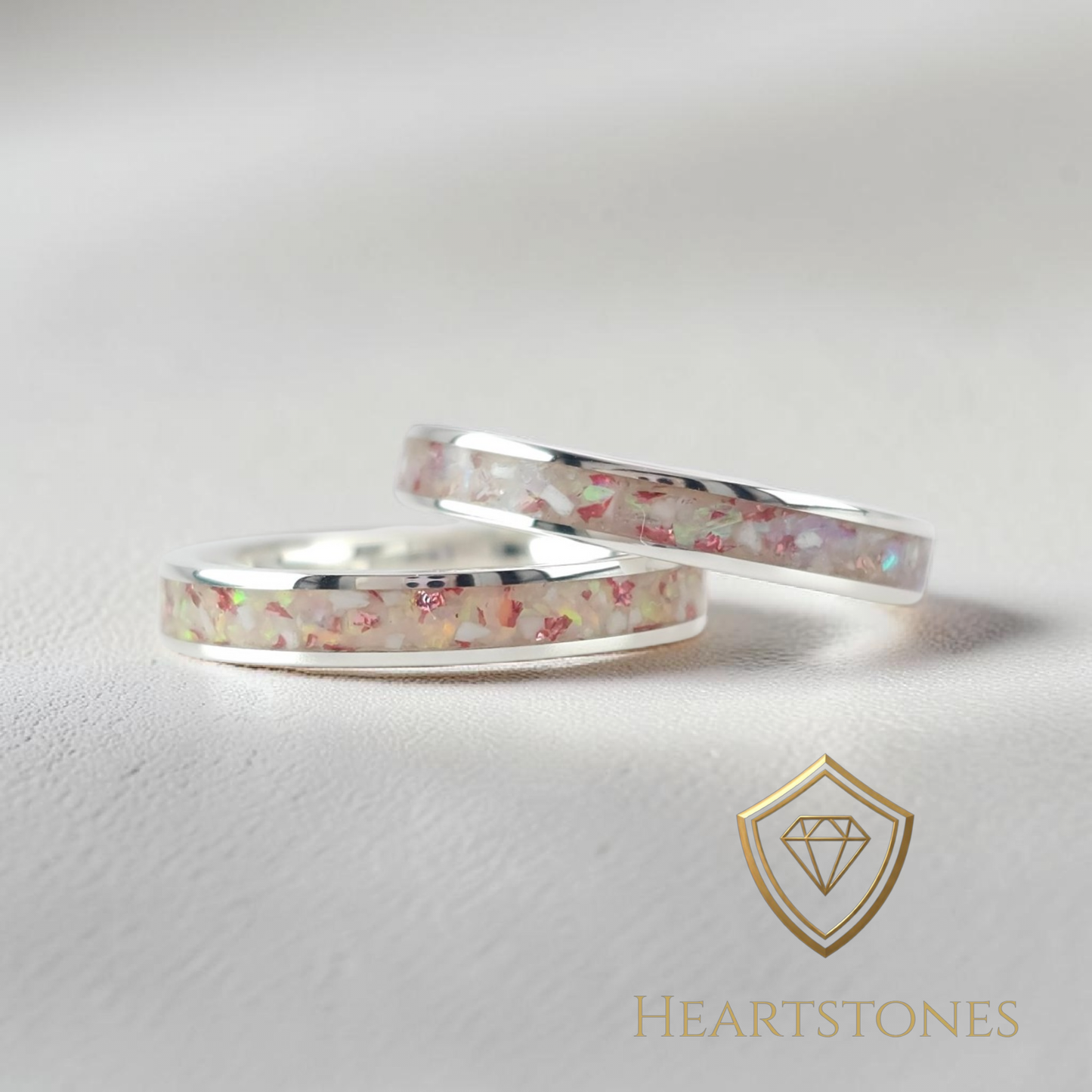 “Sterling silver memorial band rings with pastel ash and opal inlay, flush set and meticulously finished by hand by Heartstones®”