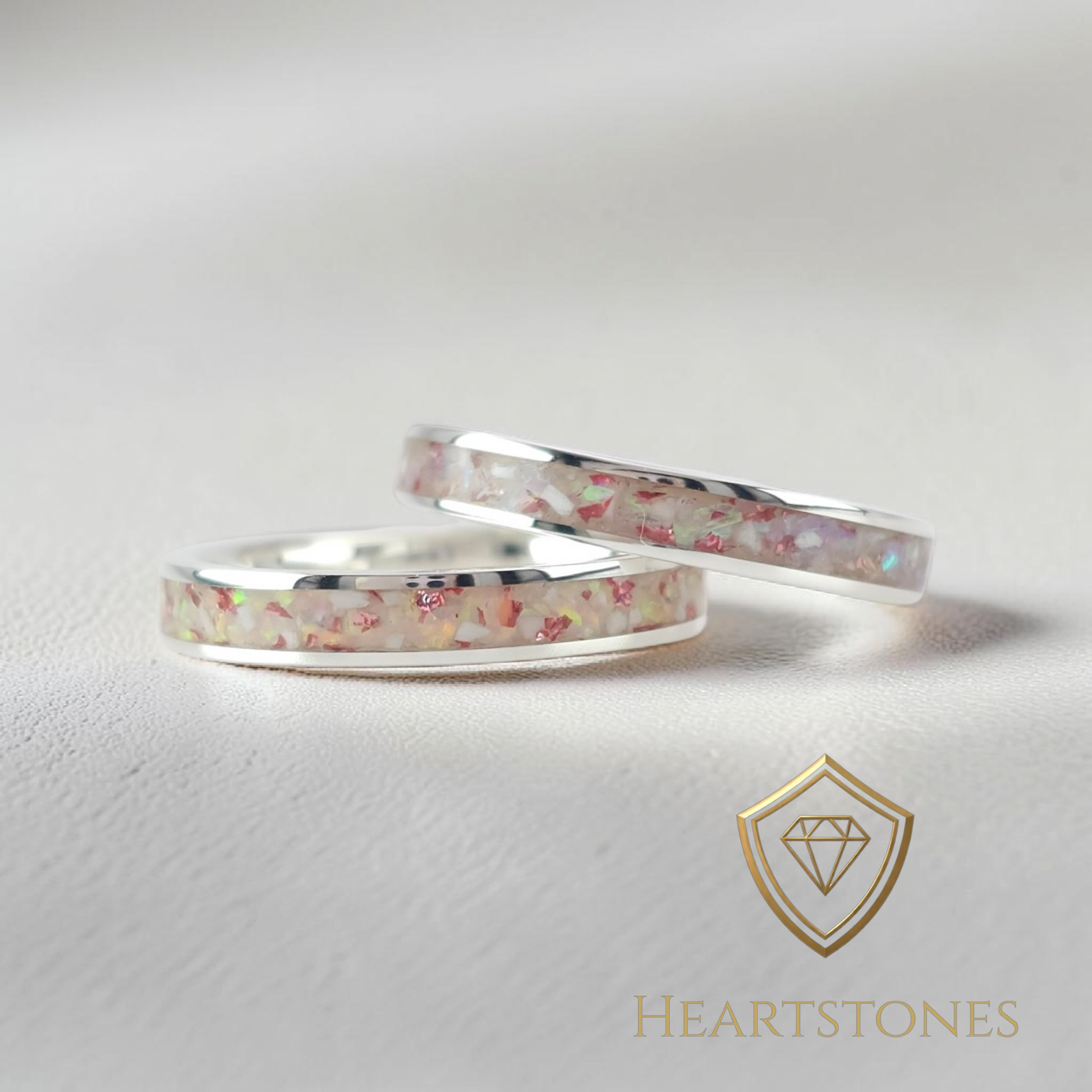 “Sterling silver memorial band rings with pastel ash and opal inlay, flush set and meticulously finished by hand by Heartstones®”