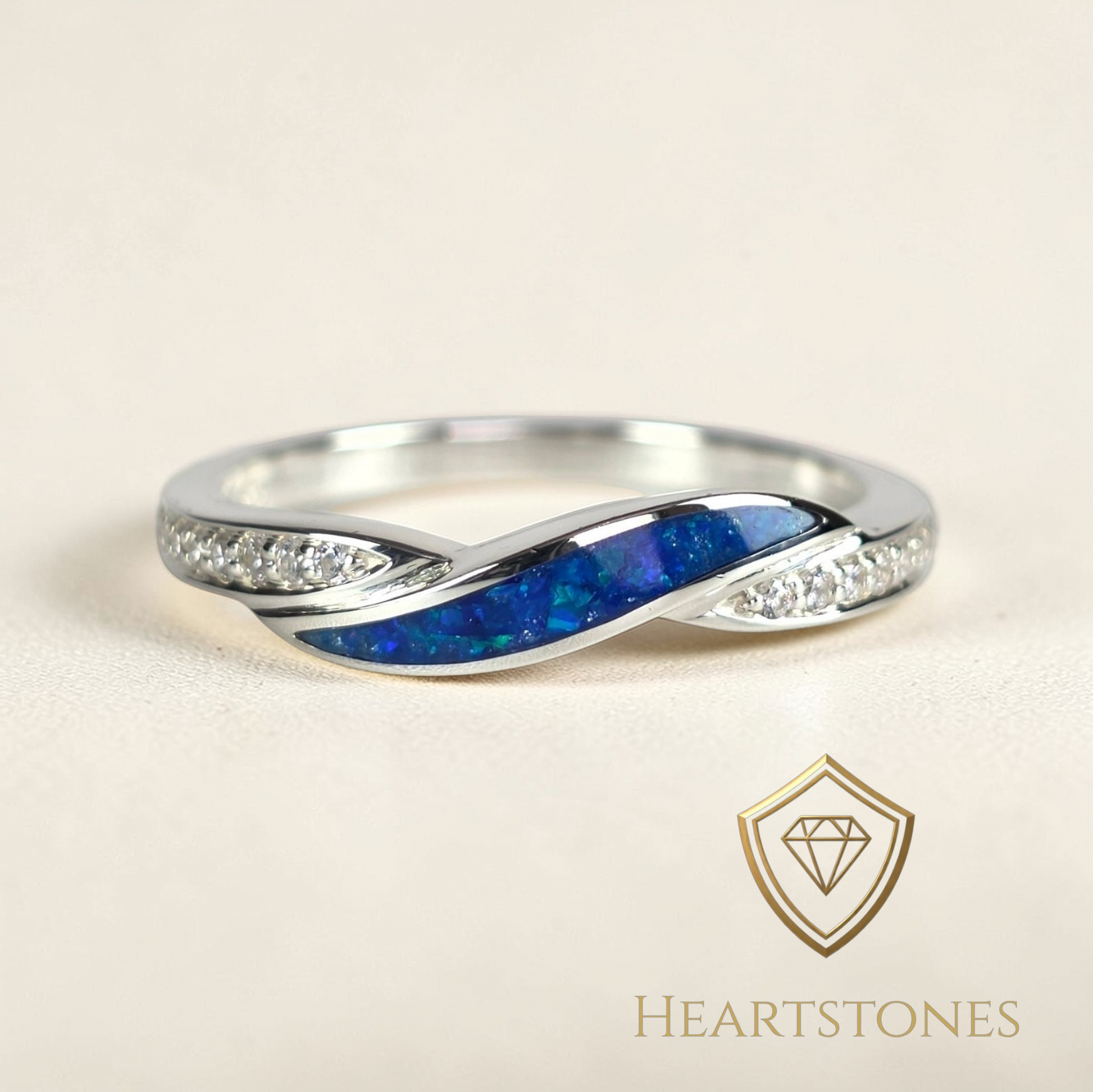 “Sterling silver twist memorial ring with blue opal and ash inlay and pavé set shoulders, meticulously finished by hand by Heartstones®”